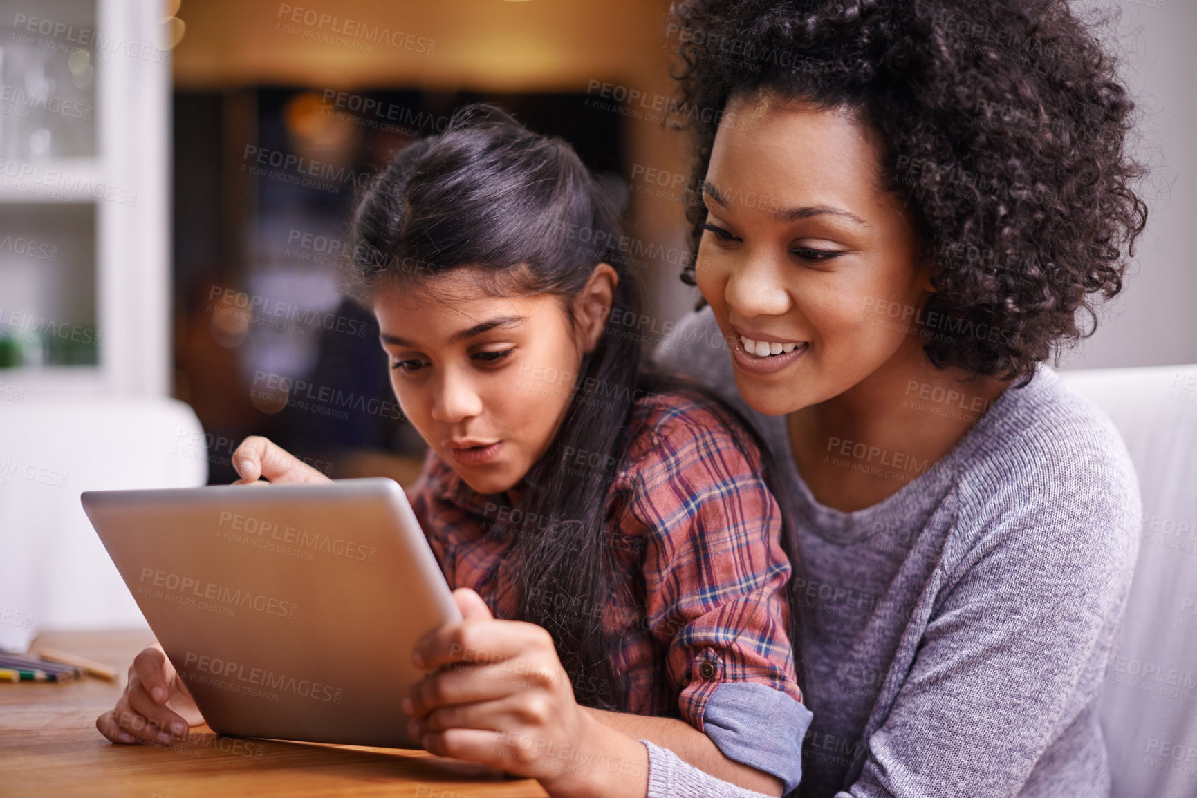 Buy stock photo Shot of a mother and daughter using a digital tablet together