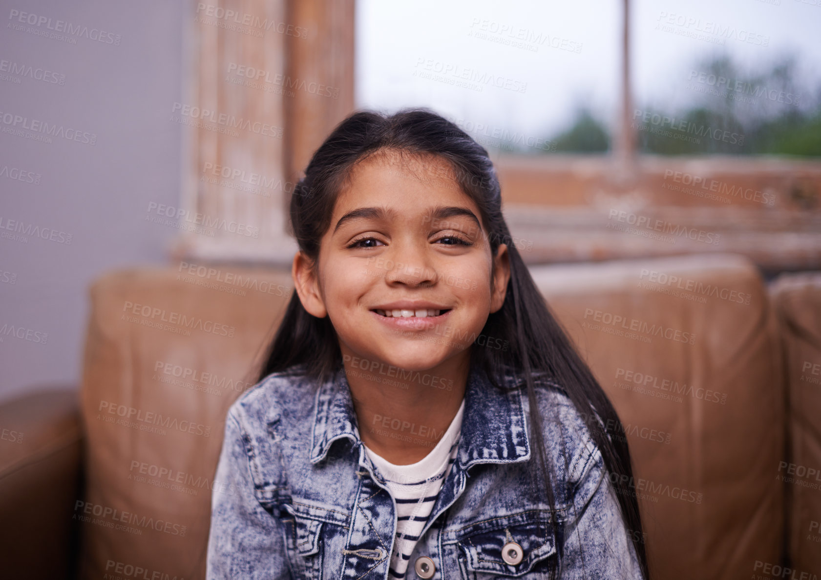 Buy stock photo Smile, portrait and girl child on sofa in living room with positive, good and confident attitude. Happy, sweet and face of cute young kid sitting on couch for relaxing in lounge at modern home.