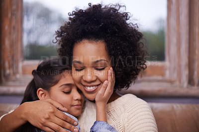 Buy stock photo Mother, child and hug on sofa in home for weekend relaxing or holiday bonding, love or support. Woman, daughter and embrace connection in apartment living room for vacation care, youth or parenting