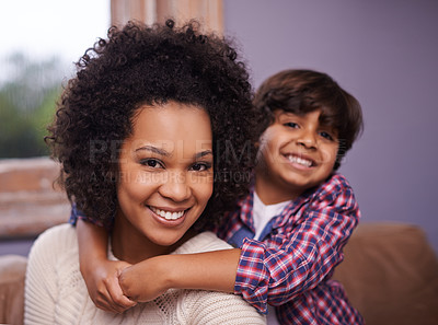 Buy stock photo Mother, child and portrait in house for hug and love for parenting, bonding and childhood. Mom, boy and smile on sofa for interracial family, son and kids for growing up, joy and young in living room