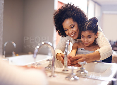 Buy stock photo Cropped shot of a mother and daughter washing their hands at the bathroom sink