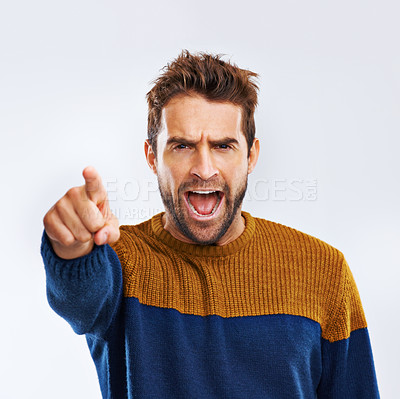 Buy stock photo Angry man, portrait and pointing to you with shout for choice, pick or frustration on a gray studio background. Frustrated male person or model yelling or screaming with mood or attitude on mockup