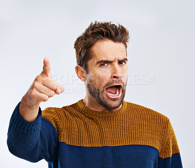 Buy stock photo Frustrated man, portrait and pointing to you with shout for choice, pick or rage on a white studio background. Angry male person or upset model yelling or screaming with mood or attitude on mockup