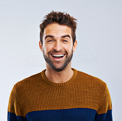 Buy stock photo Studio shot of a happy and handsome man laughing against a gray background