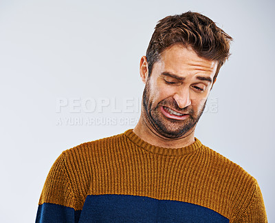 Buy stock photo Man, frown and facial expression in studio for disgust and regret for attitude, emotion and mood. Male model and  young person and isolated with face gesture or grimace for oops on white background