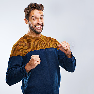 Buy stock photo Portrait, winner and man with energy, fist and excitement with guy isolated against a studio background. Face, male person and model winning, goals and happiness with victory, wow and omg with joy