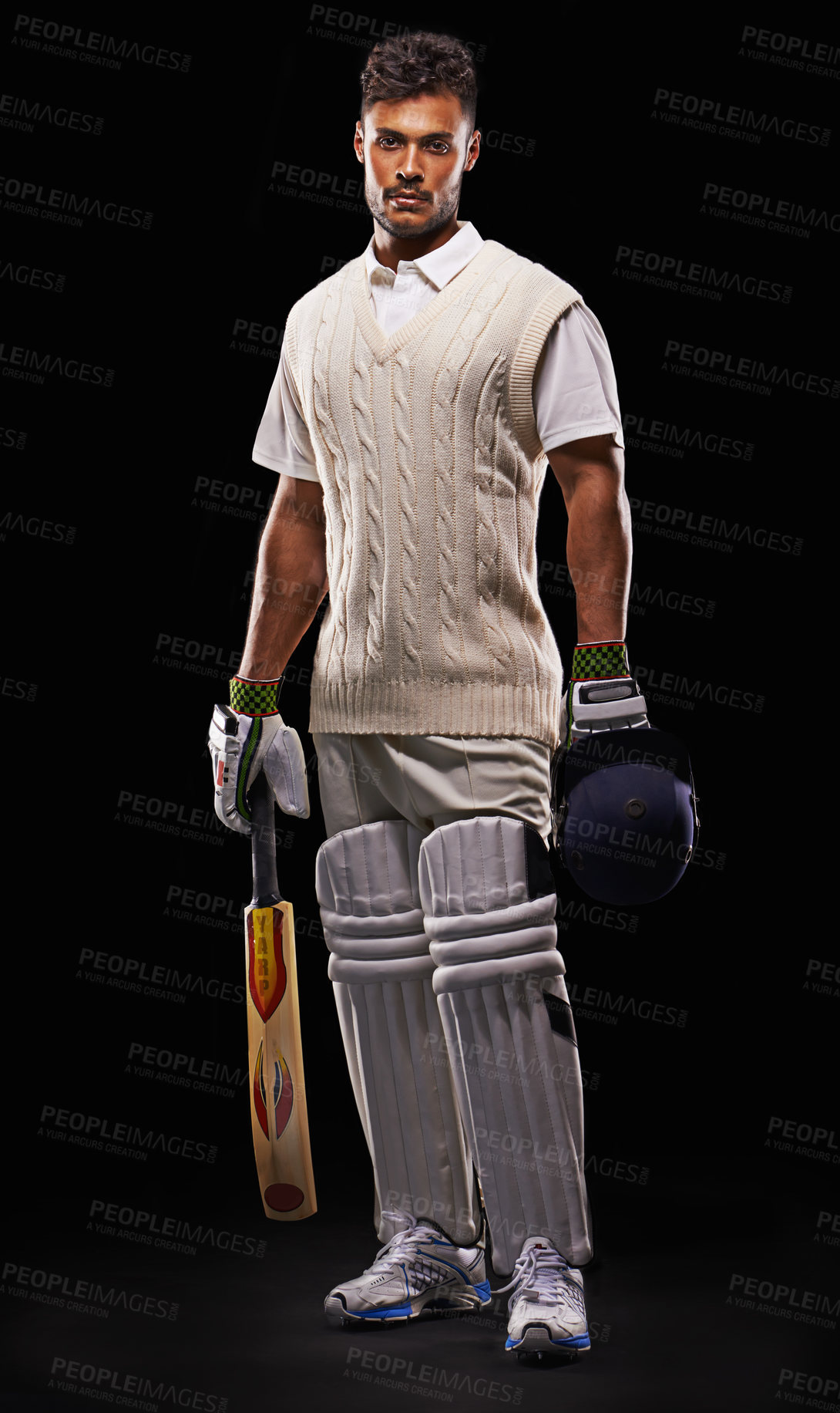 Buy stock photo A cropped shot of an ethnic young man in cricket attire isolated on black