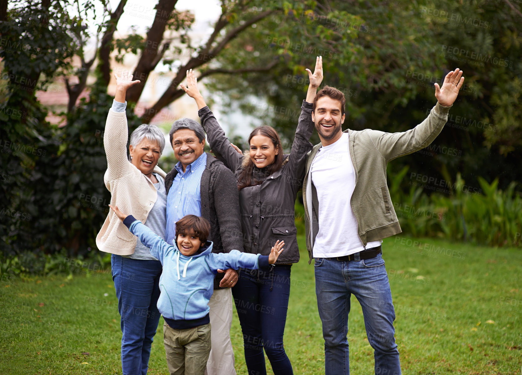 Buy stock photo Portrait, smile and big family outdoor for freedom, celebration or laugh together at backyard. Park, happy and child with parents, grandparents and mother with interracial father at garden in nature