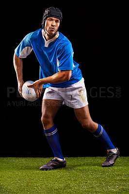 Buy stock photo Rugby, dark and man sports athlete pass a ball at night in black studio background training, wellness and fitness. Exercise, workout and professional career of sport male person or player on grass