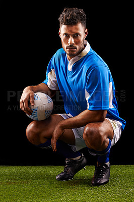 Buy stock photo Rugby, background and portrait of man at night for training, competition or sportswear dark studio. Confident, kneeling and male athlete with ball for professional sport, workout or exercise on grass