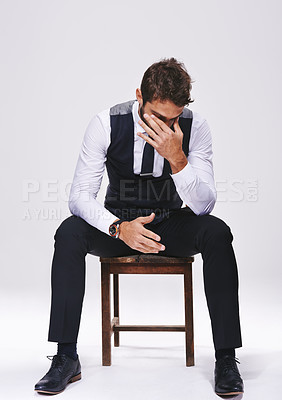 Buy stock photo Stress, fashion and man in studio with suit for elegant, trendy and classy outfit with headache. Migraine, burnout and male person in tuxedo for fancy style on chair isolated by white background.