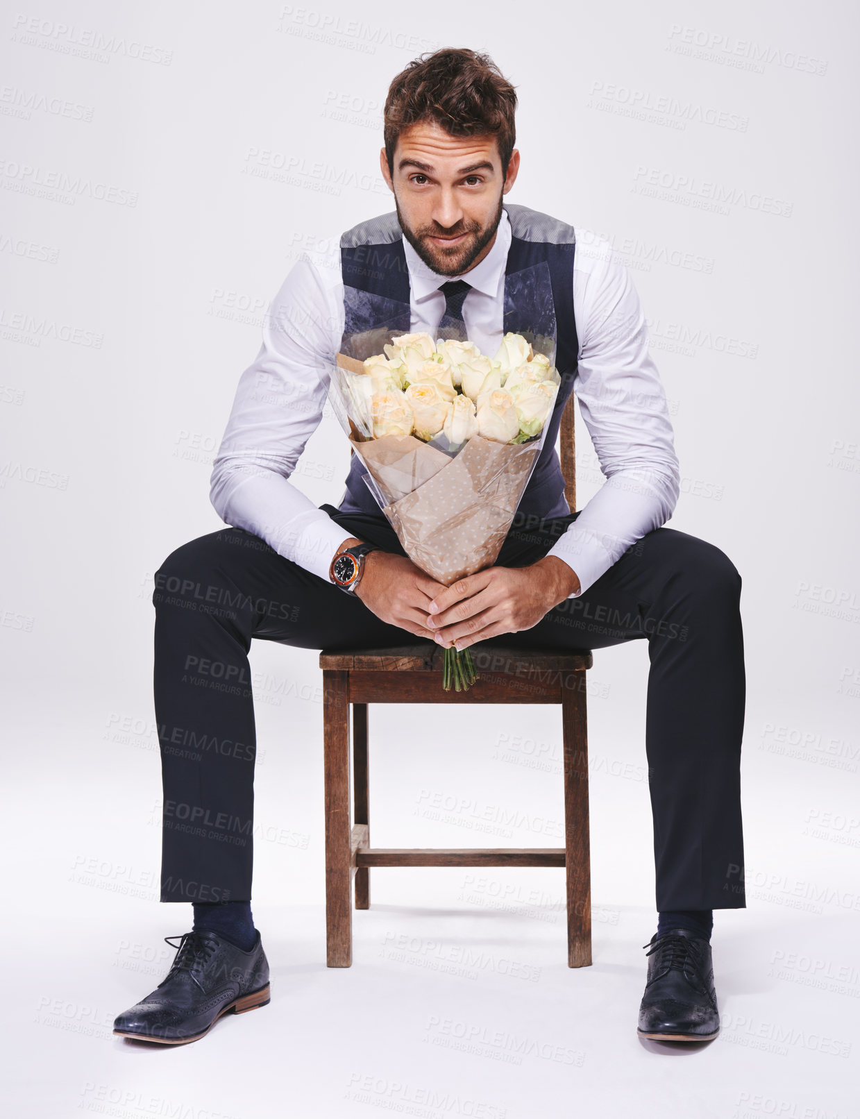 Buy stock photo Studio, portrait and man with chair, bouquet and date for style and fashion. Gentleman, designer and romance with flowers, confidence and proud ambition with suit isolated on white background