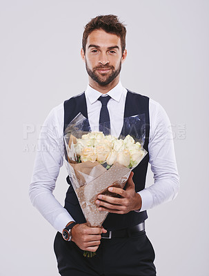 Buy stock photo Man, studio and portrait in suit with flowers, Valentines day date with smile for happiness. Celebration, natural rose bouquet and gratitude and classy male person, black tie clothes with plant