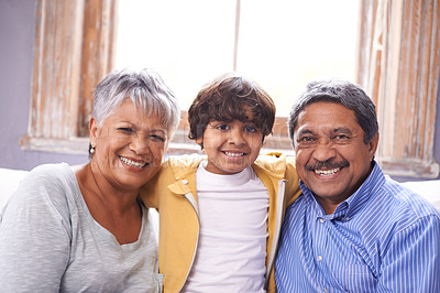 Buy stock photo Two grandparents sitting on a couch with their grandson