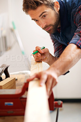 Buy stock photo Carpenter, pencil and man with wood for home improvement, building renovation and woodwork in garage. Lumber, measuring and male employee for diy, furniture restoration or manufacturing on project