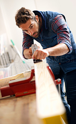 Buy stock photo Carpenter, wood and furniture with man in workshop for building, manufacturing and creative. Planning, industry and woodworker with handyman and plane in home garage for builder, lumber and design