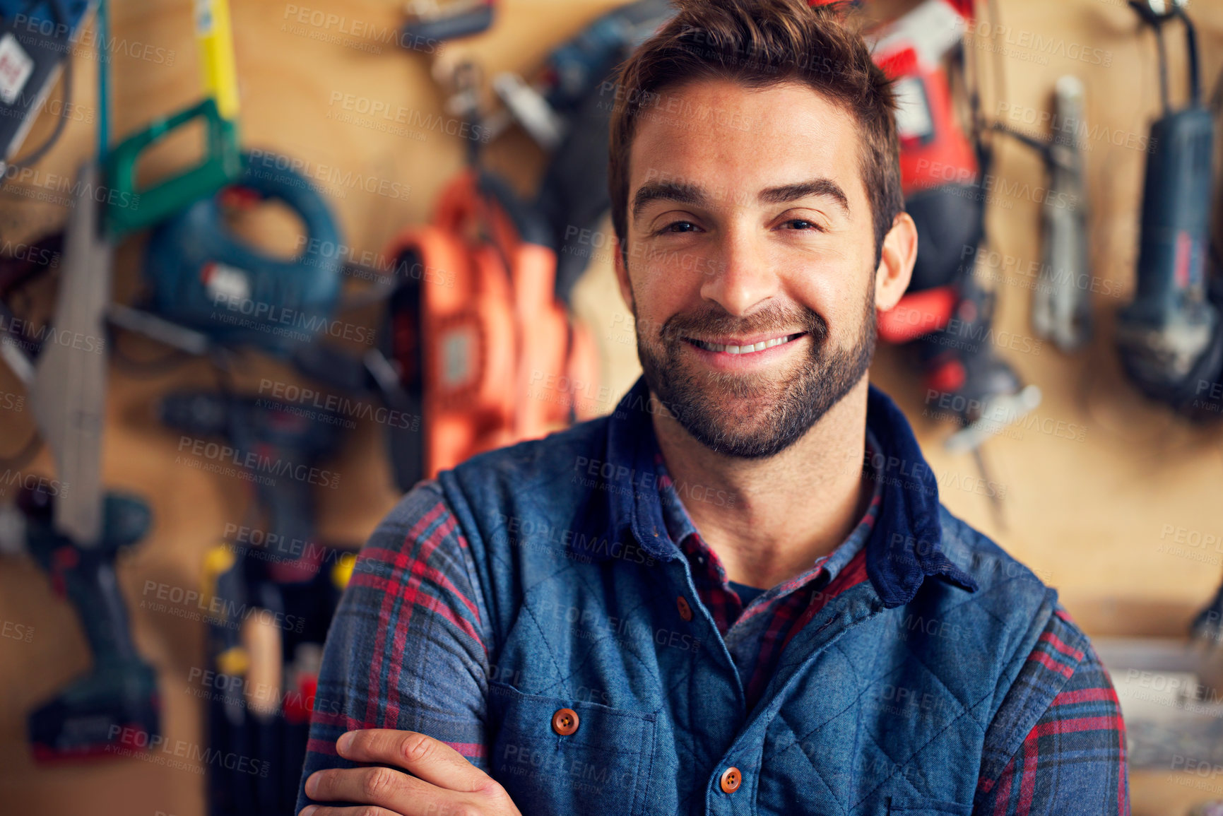 Buy stock photo Carpenter, portrait and happy man in workshop for diy, home development or building renovation. Handyman, tools and male employee for maintenance, equipment and repair work for construction in garage