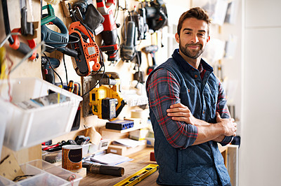 Buy stock photo Portrait of a handsome young handyman standing in front of his work tools