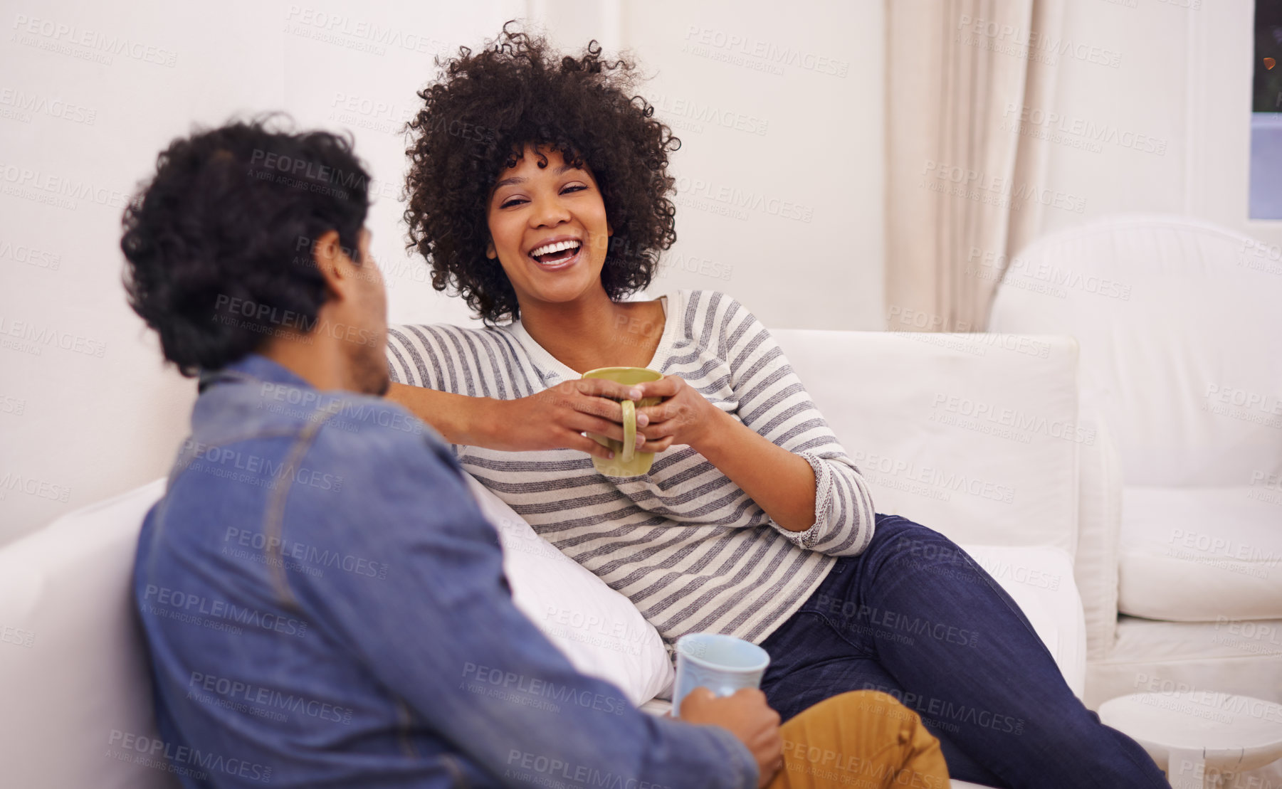 Buy stock photo Cropped shot of an affectionate young couple relaxing in their living room