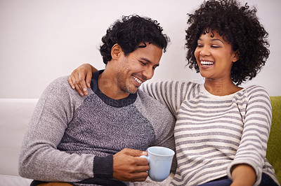 Buy stock photo Couple, couch and hug for care and coffee in home, smile and proud of marriage and commitment. Happy people, embrace and laughing on sofa in living room on weekend, support and trust in relationship