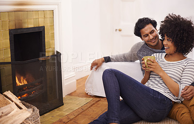 Buy stock photo Couple, fireplace and relax for care and love in home, smile and proud of marriage and commitment. Happy people, coffee and date on floor in lounge on weekend, support and trust in relationship