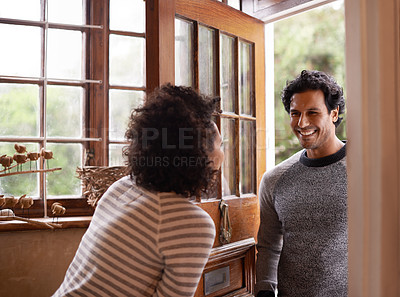 Buy stock photo Cropped shot of a young woman greeting her husband at the door