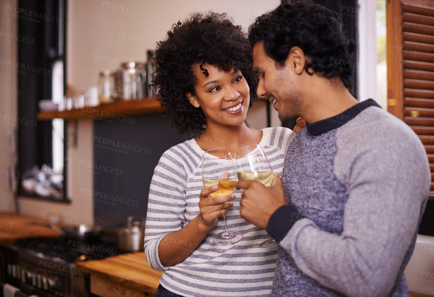 Buy stock photo Couple, wine and cheers for love, romance and passion for romantic, dating and relationship together. Boyfriend, girlfriend and young people for interracial pair for happy and drink in kitchen