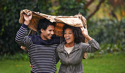 Buy stock photo Cropped shot of an affectionate young couple trying to escape the rain