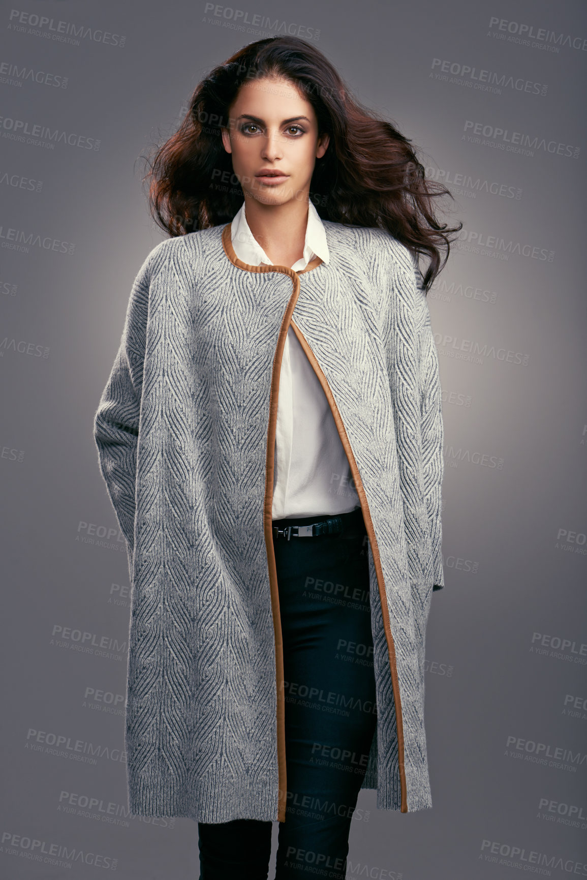 Buy stock photo Studio shot of a stylishly dressed young woman against a gray background