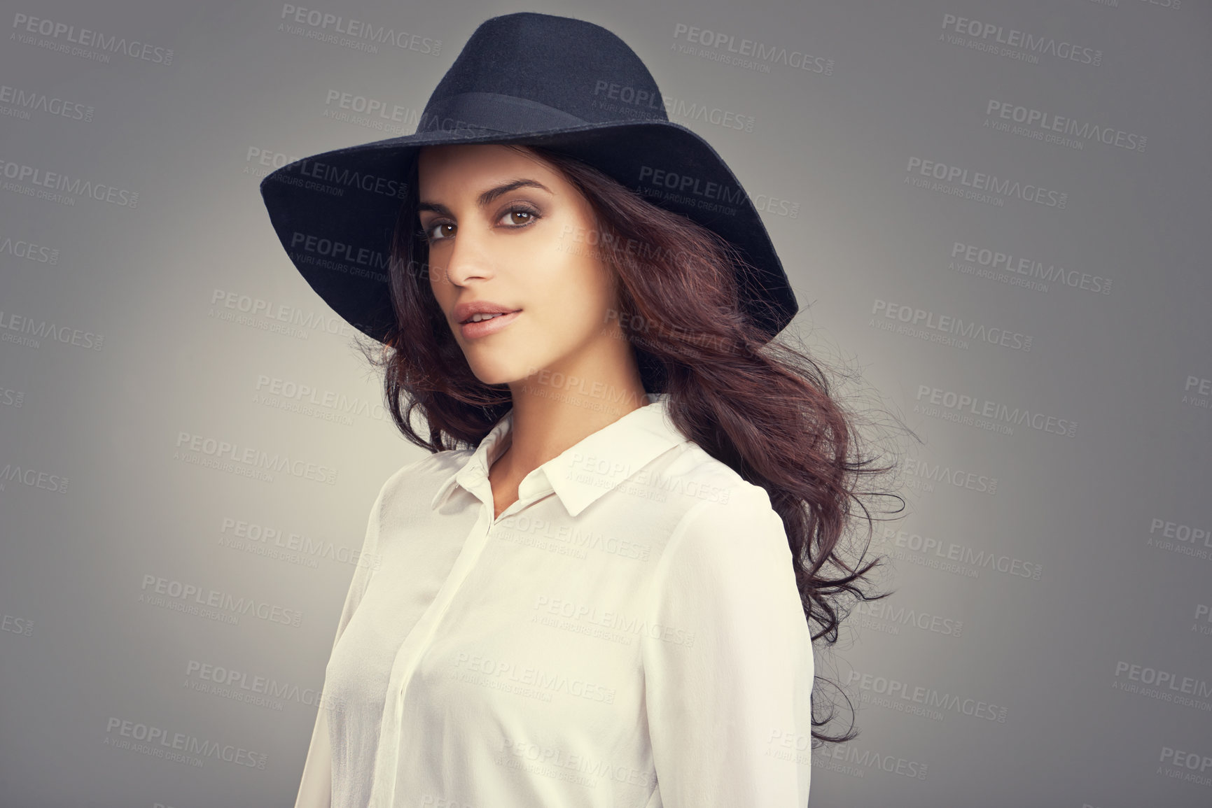 Buy stock photo Fashion, beauty and portrait of woman in studio with classy, trendy and stylish hat for outfit. Confident, makeup and young female person with elegant style and accessory isolated by gray background.