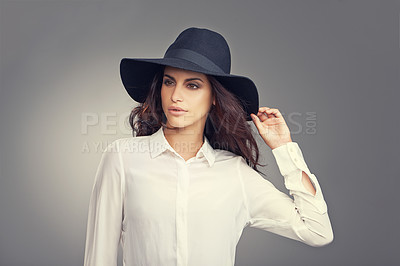 Buy stock photo Fashion, thinking and young woman in studio with classy, trendy and stylish hat for outfit. Confident, makeup and female person with ideas for elegant style and accessory isolated by gray background.