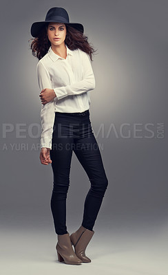 Buy stock photo Studio shot of a stylishly dressed young woman against a gray background