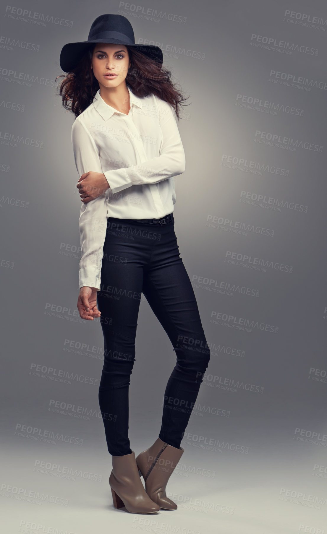 Buy stock photo Studio shot of a stylishly dressed young woman against a gray background