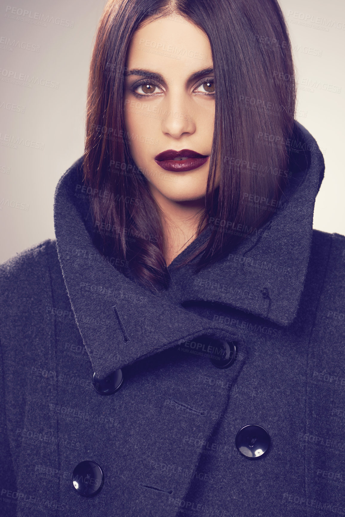 Buy stock photo Studio shot of a stylishly dressed young woman against a gray background