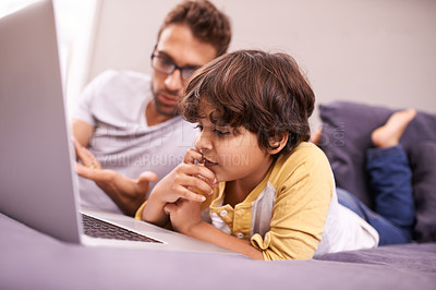 Buy stock photo Thinking, father and child with computer for learning in bedroom with connectivity, technology at home. Family, man and young boy in bed with laptop for online studying and bonding together in house