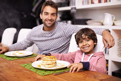 Buy stock photo Portrait of a father and son having breakfast together