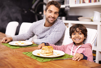 Buy stock photo Portrait, father and child with breakfast in morning with smile, happiness and bonding with food. Family, man and kid in kitchen at home hungry, eating and nutrition with meal for energy in house
