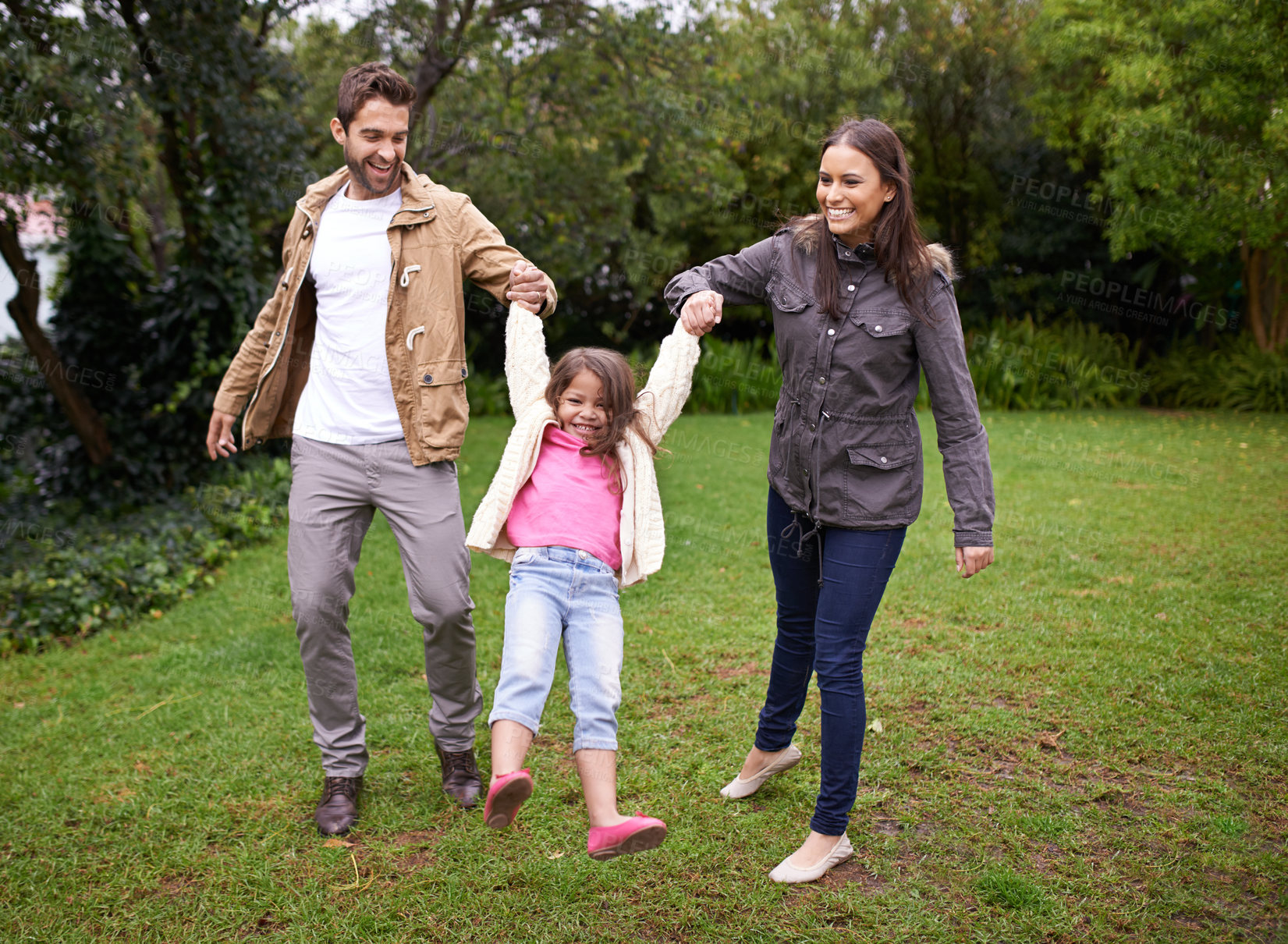 Buy stock photo Mom, dad and child holding hands in park with love, bonding and support at outdoor family adventure. Smile, parents and girl on playful walk in garden together with happy man, woman and kid in nature