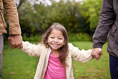 Buy stock photo Portrait, parents and child holding hands in park with smile, support and trust on outdoor adventure. Love, fun and face of girl with family in garden for happy holiday, nature or walking in backyard