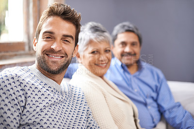 Buy stock photo Cropped portrait of a senior couple sitting with their adult son at home