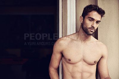 Buy stock photo Cropped shot of a shirtless young man at home