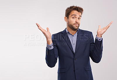 Buy stock photo Studio shot of a businessman shrugging against a gray background