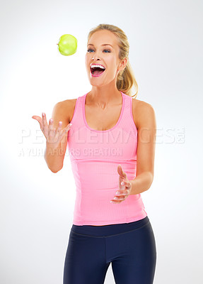Buy stock photo Woman, apple and wellness in studio for health, nutrition and play with fruit on white background. Female person, happy and organic snack or vegan diet for wellbeing, vitamins and minerals in fiber