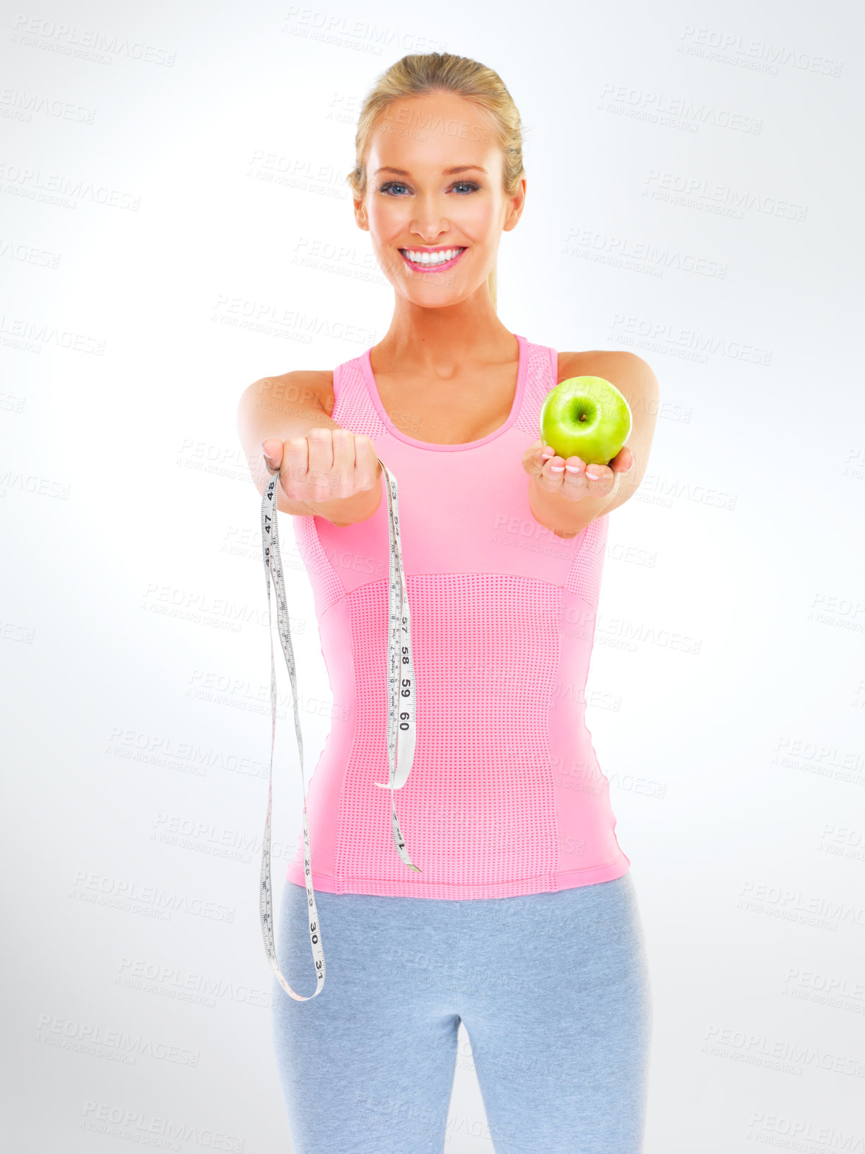 Buy stock photo Woman, portrait and apple with measuring tape for nutrition  weight loss or hungry, wellness or white background. Female person, face and eating fruit in studio for training routine, diet or mockup