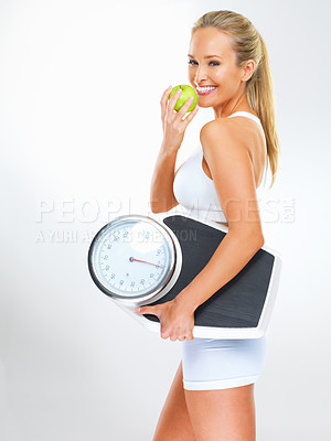Buy stock photo Woman, portrait and scale or apple for health, studio and excited for results of diet or detox. Female person, nutrition and journey for calories burned target, organic snack and white background