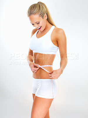 Buy stock photo Woman, tape measure and lose weight results in studio for healthy progress with workout training, nutrition or white background. Female person, excited and diet wellness for target, goals or mockup