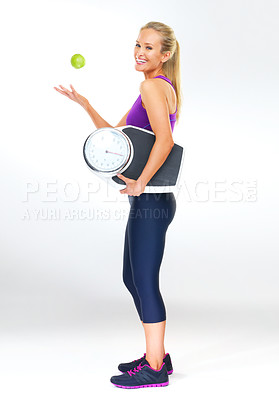 Buy stock photo Woman, portrait and scale or apple for balance, studio and excited for results of diet or detox. Female person, nutrition and journey for calories burned target, organic snack and white background