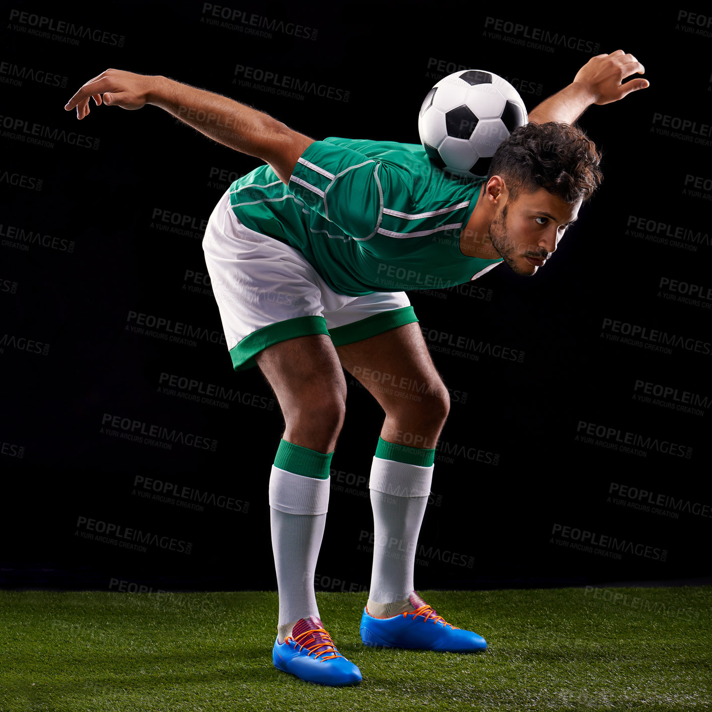 Buy stock photo Man, ball and soccer for balance, sport and match for fitness, game and active for sportswear on grass or field. Arab person, role model or athlete and practice for competitive on dark background
