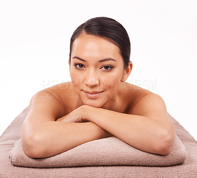 Buy stock photo Smile, portrait and woman at spa for massage with skincare, grooming or body treatment in studio. Happy, health and face of Asian female person on table for relaxing routine by white background.