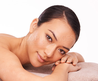 Buy stock photo Wellness, portrait and woman at spa for massage with skincare, grooming or body treatment in studio. Happy, health and face of Asian female person on table for relaxing routine by white background.